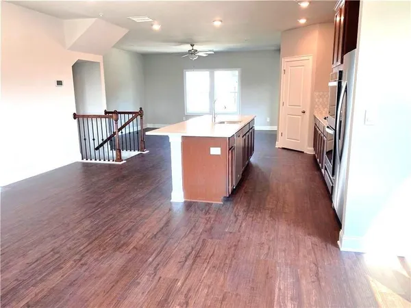 a hall with wooden floor and a sink