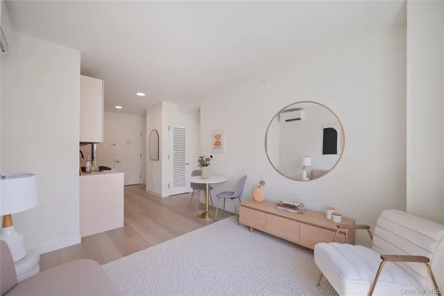 a living room with furniture and a mirror
