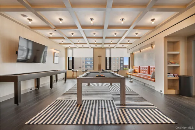 a kitchen with stainless steel appliances granite countertop a table chairs sink and cabinets