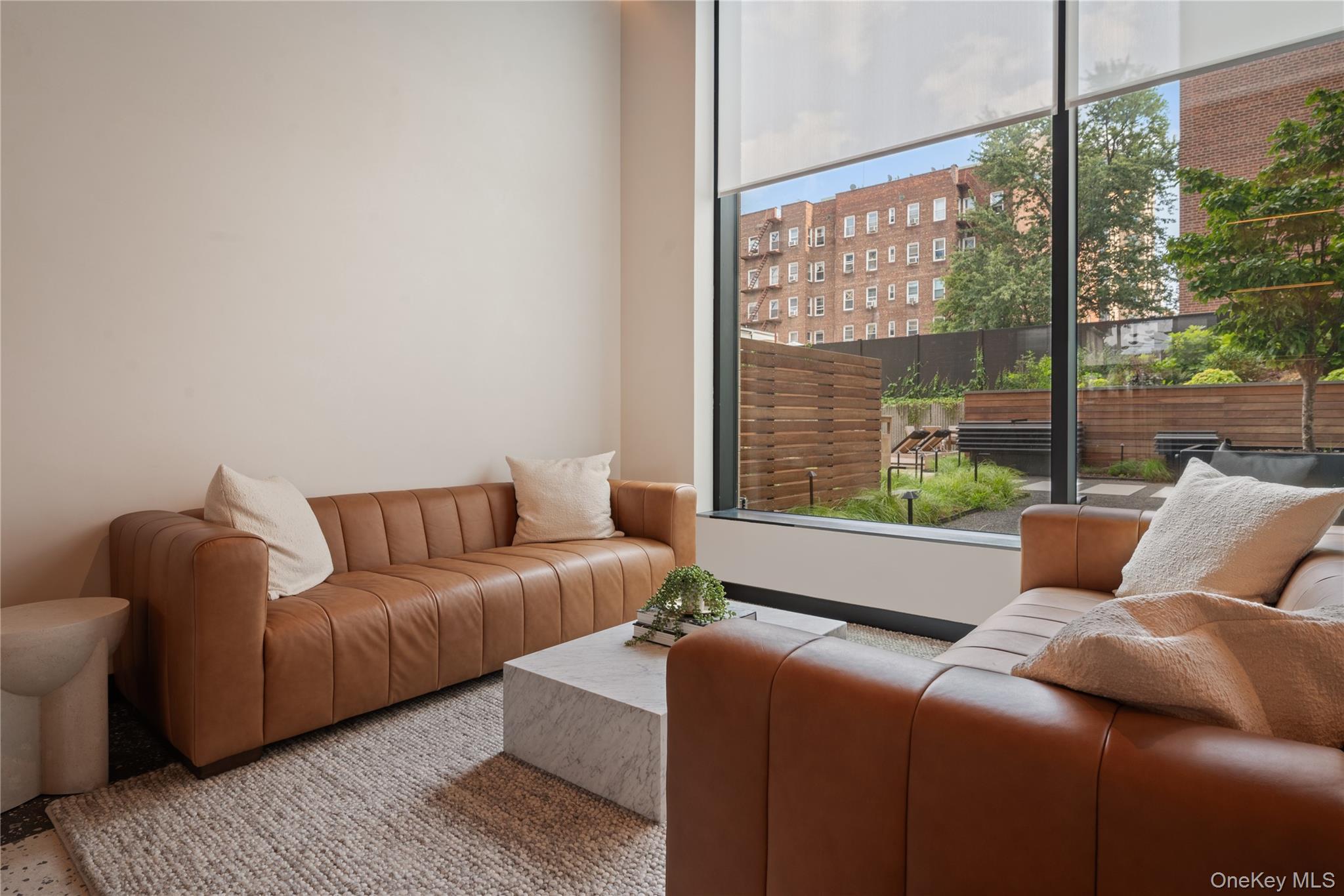 103 88th Avenue Queens, NY 11432 - Photo 23 of 29 a living room with furniture and a large window