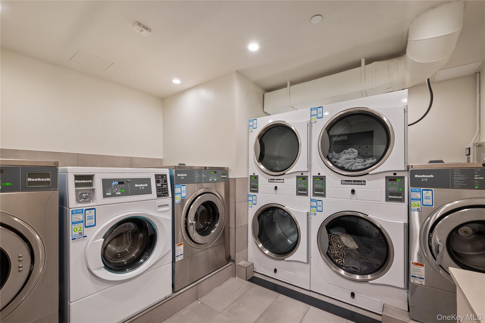 103 88th Avenue Queens, NY 11432 - Photo 25 of 29 a view of kitchen with washer and dryer
