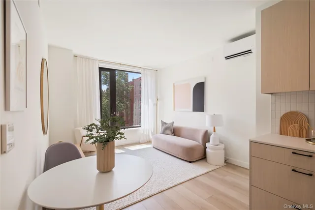 a living room with furniture flowerpot and window
