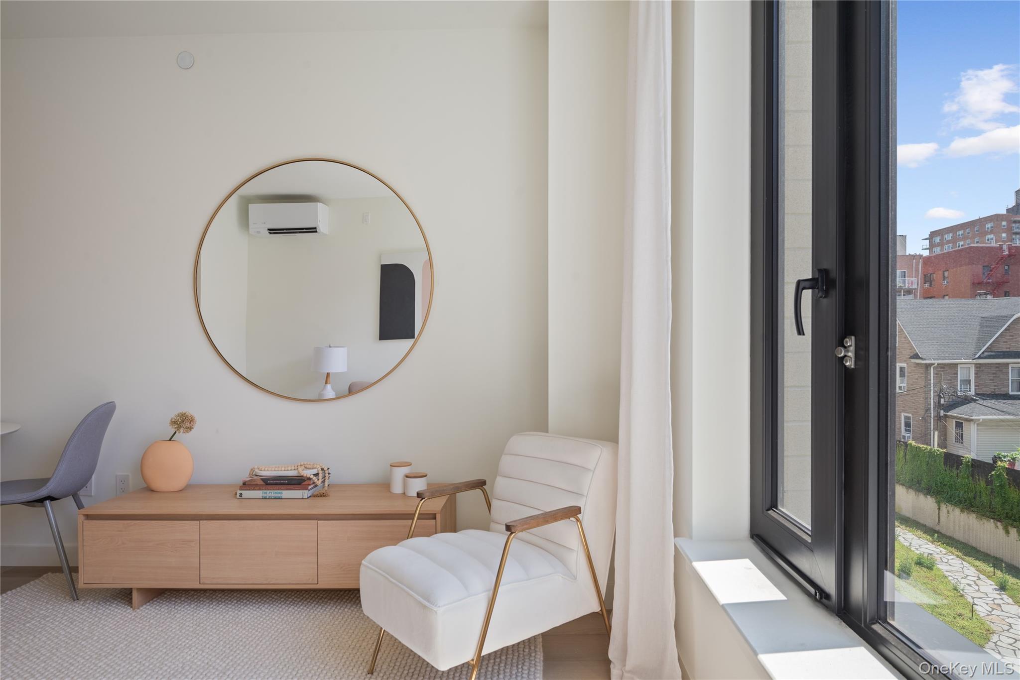 103 88th Avenue Queens, NY 11432 - Photo 4 of 29 a living room with furniture a mirror and a window
