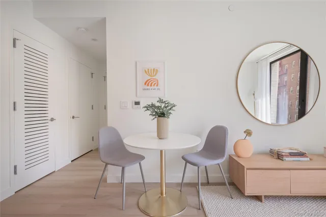 a dining room with furniture and a mirror