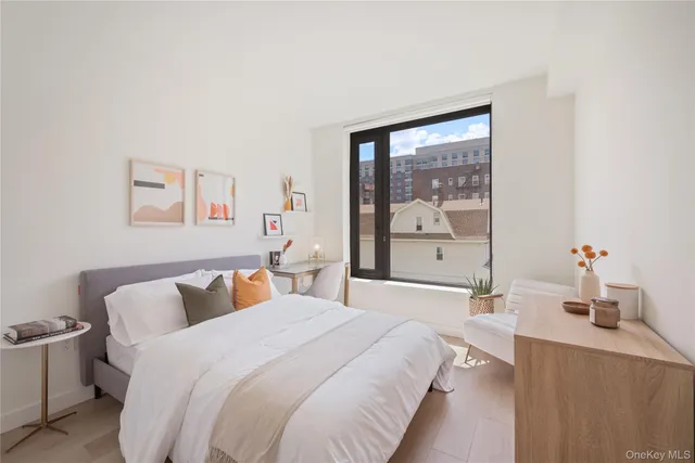 a bedroom with a large bed and a large window