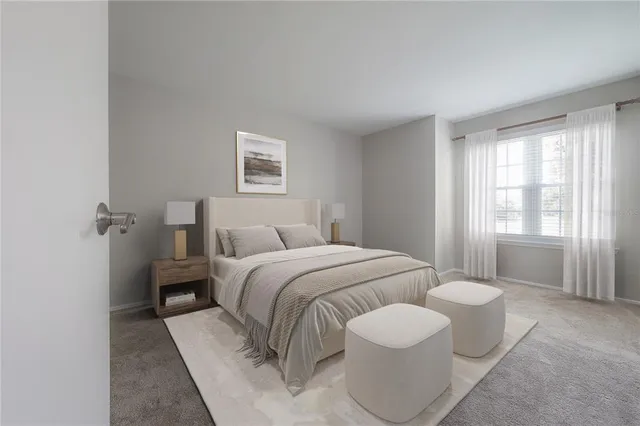 a bedroom with a bed and a painting