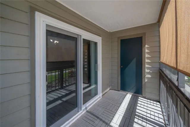 a view of a lake with a yard and large trees