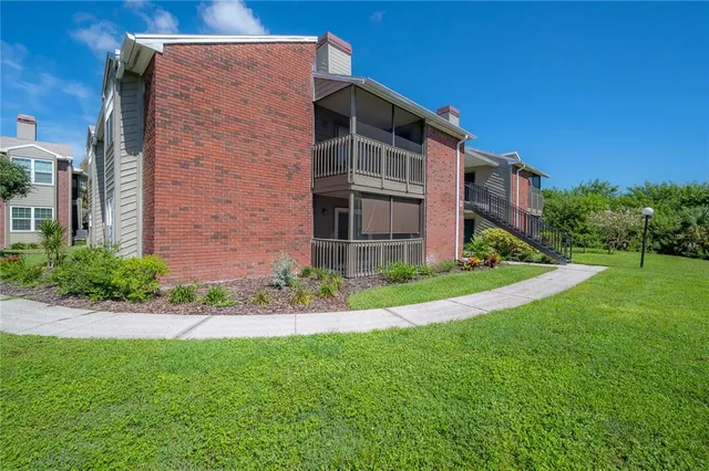 a view of backyard with potted plants and floor to ceiling window