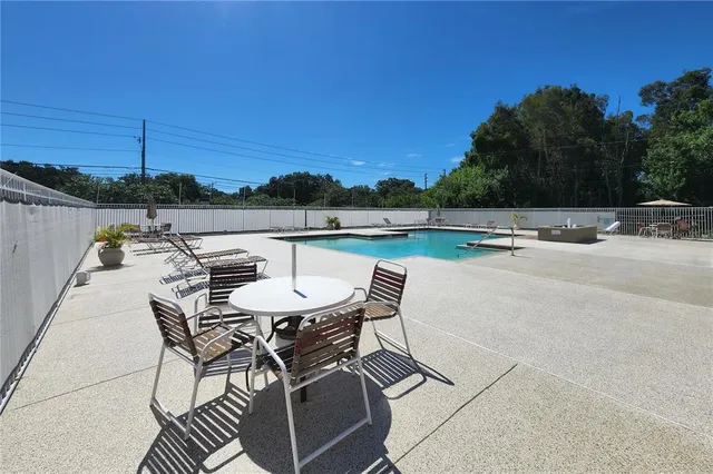 a view of swimming pool with outdoor seating and plants