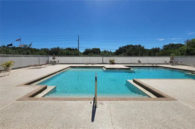 a view of a house with backyard and a tree