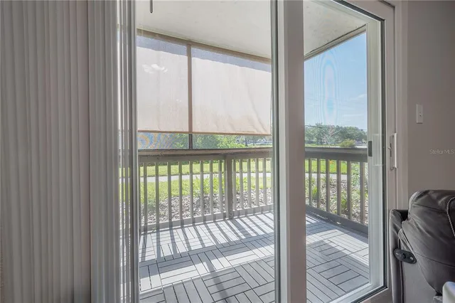 a view of a room with wooden floor and windows