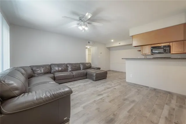 a living room with furniture and kitchen view