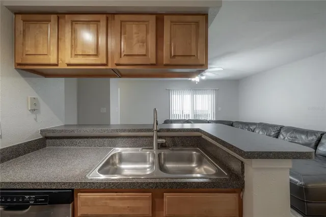 a kitchen with granite countertop a sink and cabinets