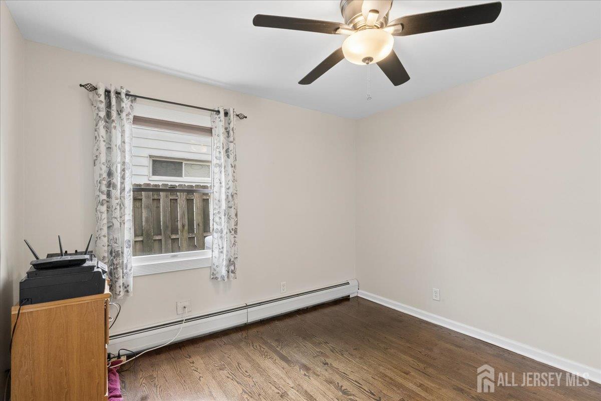45 Walnut Street Edison, NJ 08817 - Photo 15 of 28 an empty room with a window and a ceiling fan