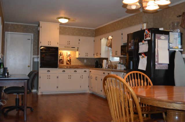 86 Sears Roebuck Road Tullahoma, TN 37388 - Photo 4 of 16 From the Hall, step into the Kitchen/Breakfast Area. This Kitchen offers TONS of space for cooking & enjoying the company of your family & friends. Notice the great counter space, ample cabinetry, built in oven, cooktop stove, & HW laminate flooring