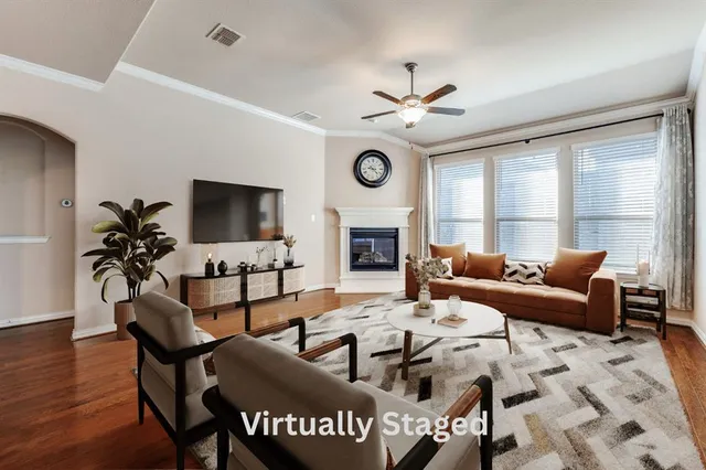a living room with furniture a fireplace and a flat screen tv