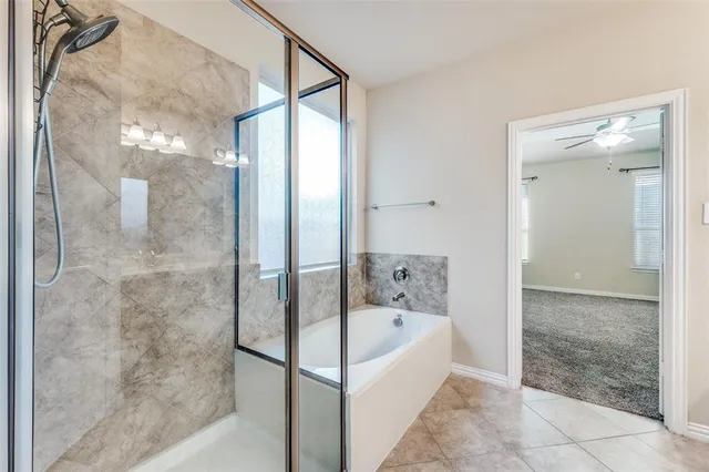 a bathroom with a bathtub and shower