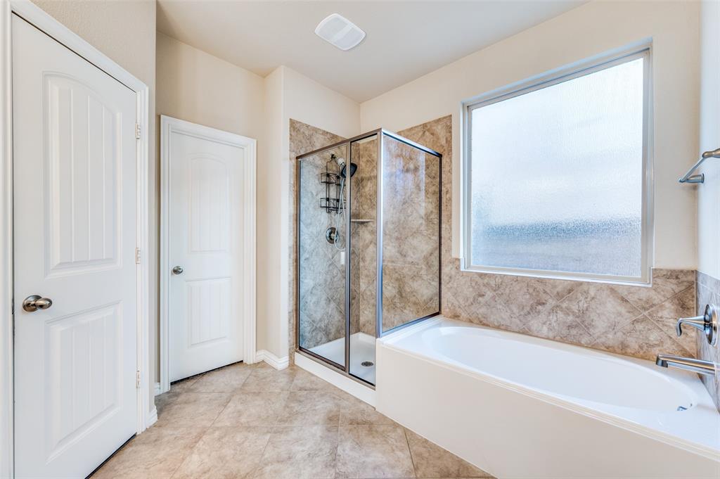 16008 Aquilla Way Prosper, TX 75078 - Photo 18 of 33 a bathroom with a bathtub and a shower