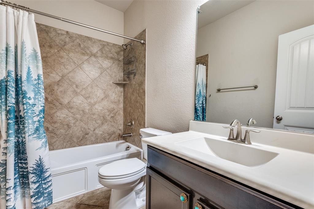 16008 Aquilla Way Prosper, TX 75078 - Photo 20 of 33 a bathroom with a sink a toilet and shower