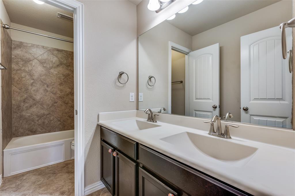 16008 Aquilla Way Prosper, TX 75078 - Photo 23 of 33 a bathroom with a granite countertop sink and a mirror