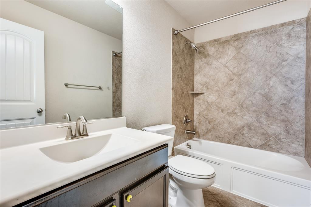 16008 Aquilla Way Prosper, TX 75078 - Photo 26 of 33 a bathroom with a sink a toilet and a bathtub