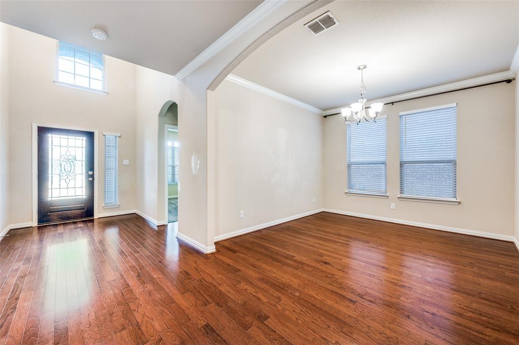 16008 Aquilla Way Prosper, TX 75078 - Photo 4 of 33 a view of an empty room with wooden floor and a window