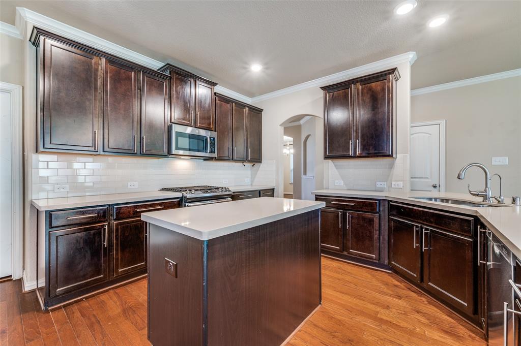 16008 Aquilla Way Prosper, TX 75078 - Photo 8 of 33 a kitchen with stainless steel appliances granite countertop a stove microwave and sink