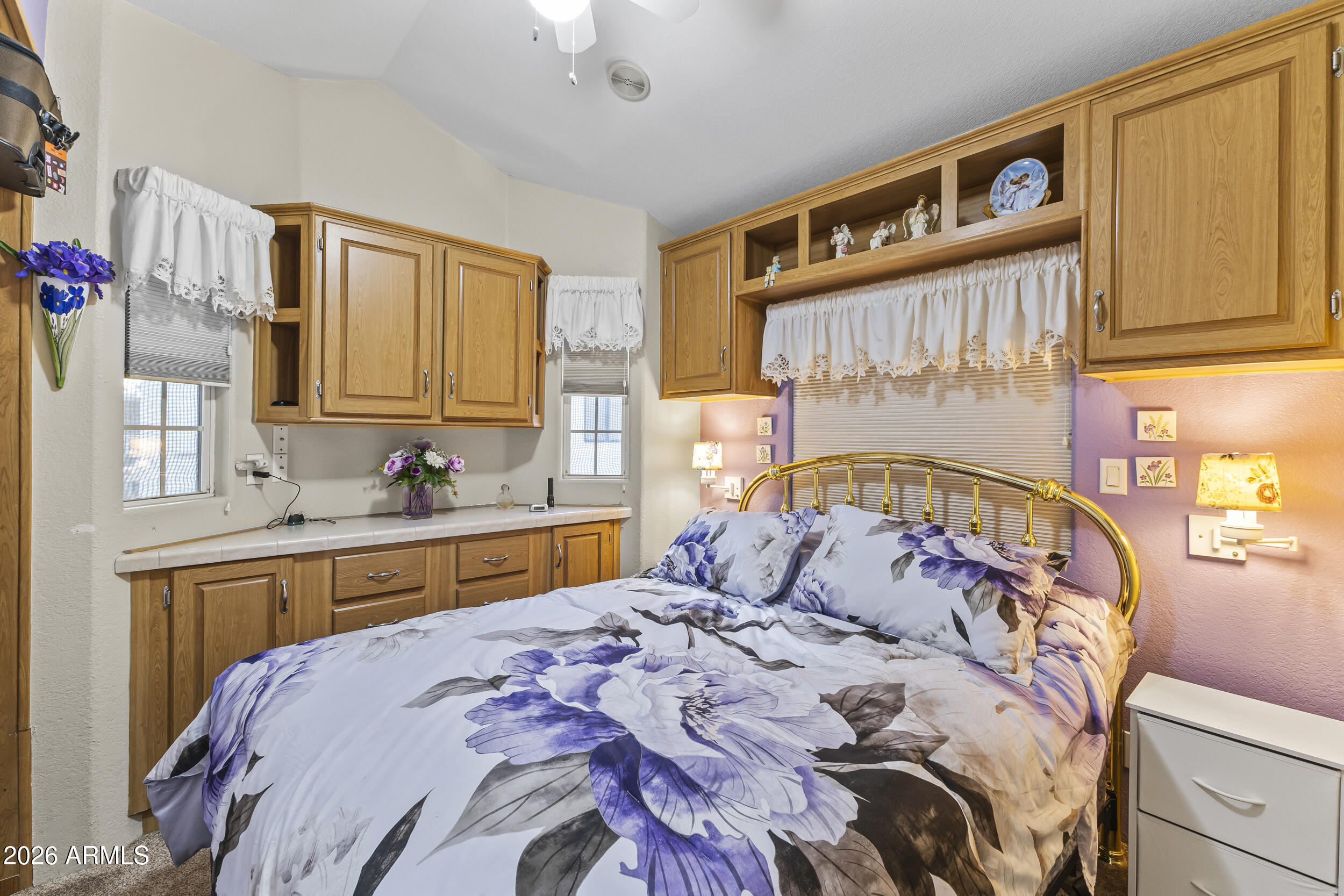 17200 West Bell Road, Unit 548 Surprise, AZ 85374 - Photo 12 of 19 a large bed sitting in a bedroom next to a window