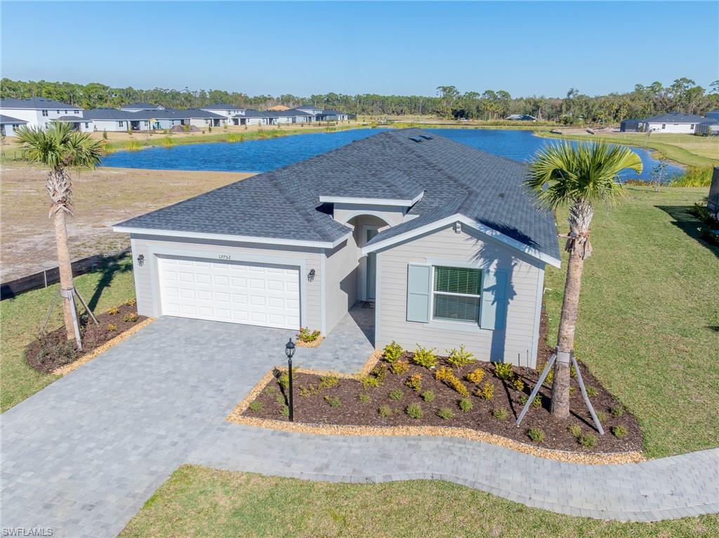 17752 Saddleback Loop North Fort Myers, FL 33917 - Photo 1 of 37 Ranch-style house with a garage, decorative driveway, a front lawn, and a water view
