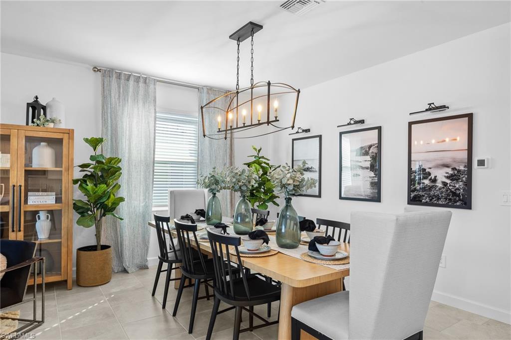 17752 Saddleback Loop North Fort Myers, FL 33917 - Photo 15 of 37 Dining space with a chandelier and baseboards