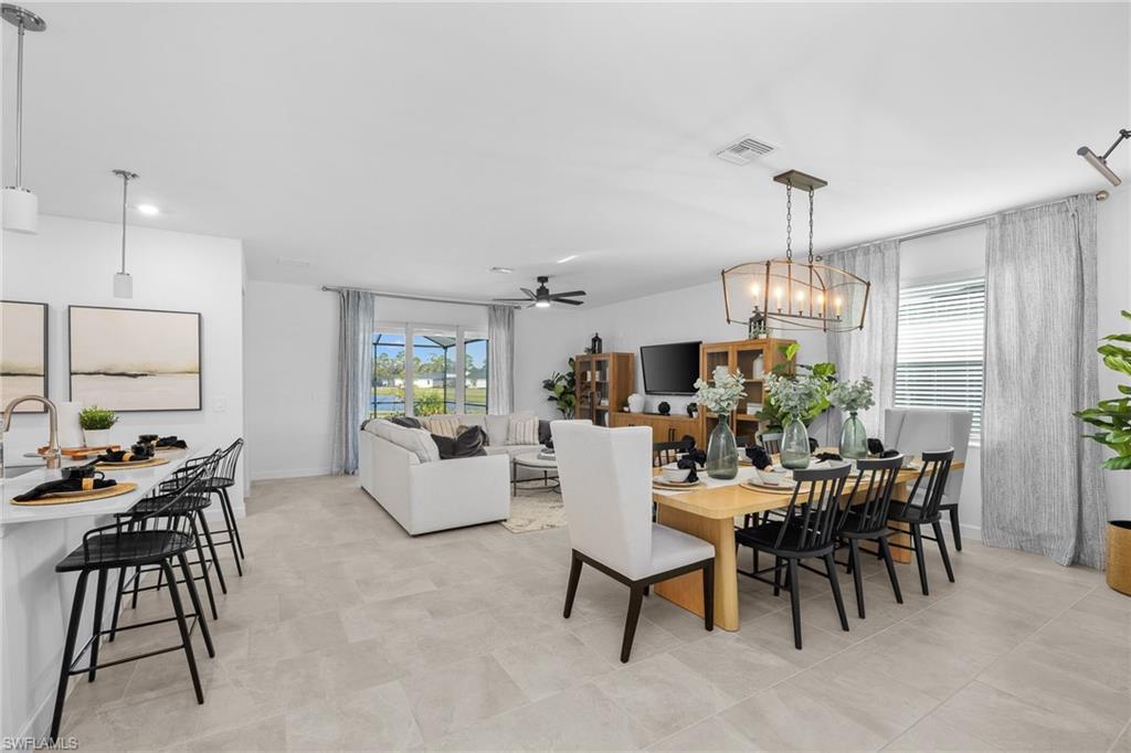 17752 Saddleback Loop North Fort Myers, FL 33917 - Photo 16 of 37 Dining space featuring a ceiling fan and a chandelier