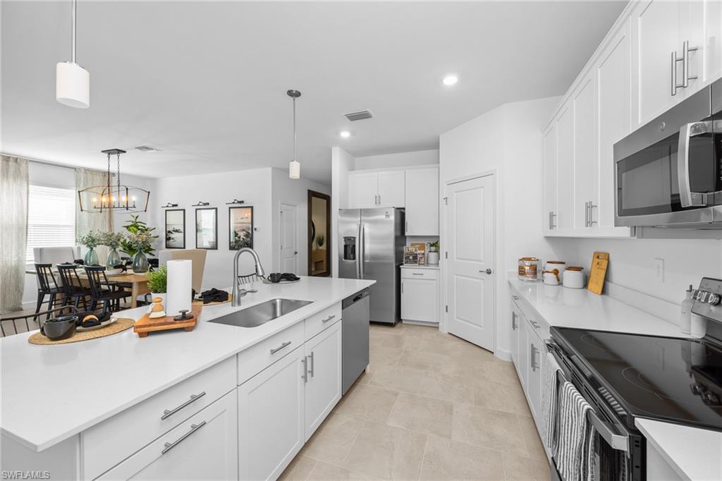 17752 Saddleback Loop North Fort Myers, FL 33917 - Photo 18 of 37 Kitchen featuring stainless steel appliances, white cabinets, light countertops, hanging light fixtures, and recessed lighting