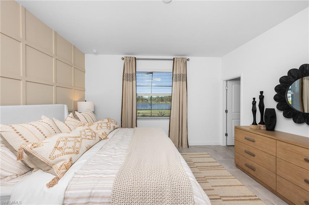17752 Saddleback Loop North Fort Myers, FL 33917 - Photo 19 of 37 Bedroom with light tile patterned floors and a decorative wall