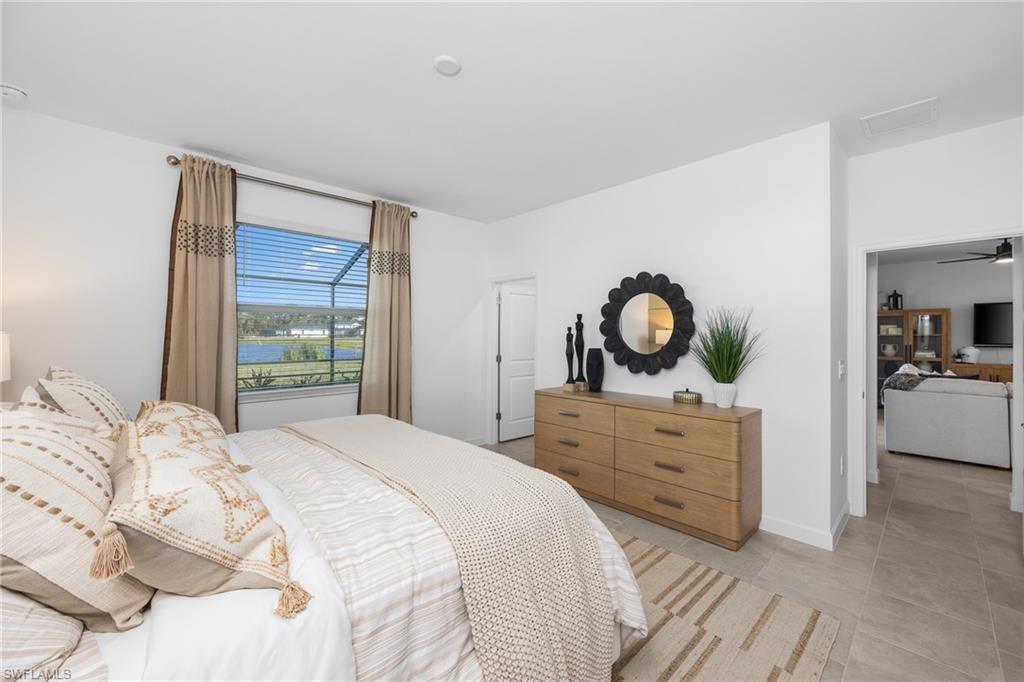 17752 Saddleback Loop North Fort Myers, FL 33917 - Photo 21 of 37 Bedroom with light tile patterned floors and a water view