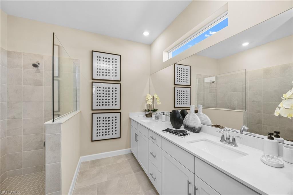 17752 Saddleback Loop North Fort Myers, FL 33917 - Photo 24 of 37 Full bath featuring double vanity, walk in shower, tile patterned floors, and recessed lighting