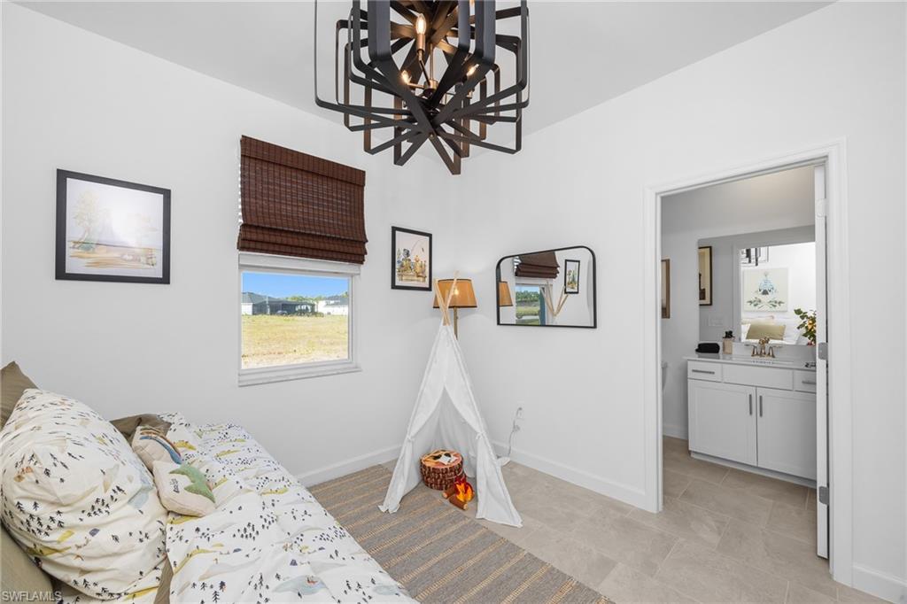 17752 Saddleback Loop North Fort Myers, FL 33917 - Photo 26 of 37 Bedroom with a chandelier, light tile patterned floors, and ensuite bathroom