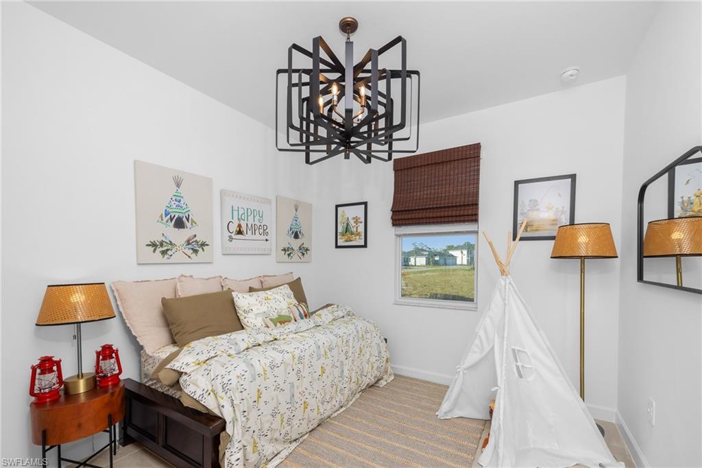 17752 Saddleback Loop North Fort Myers, FL 33917 - Photo 27 of 37 Bedroom with a chandelier and baseboards