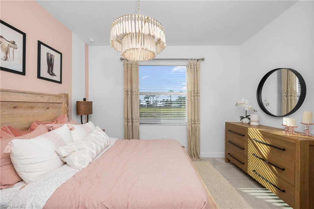 17752 Saddleback Loop North Fort Myers, FL 33917 - Photo 29 of 37 Bedroom featuring a chandelier and light tile patterned flooring