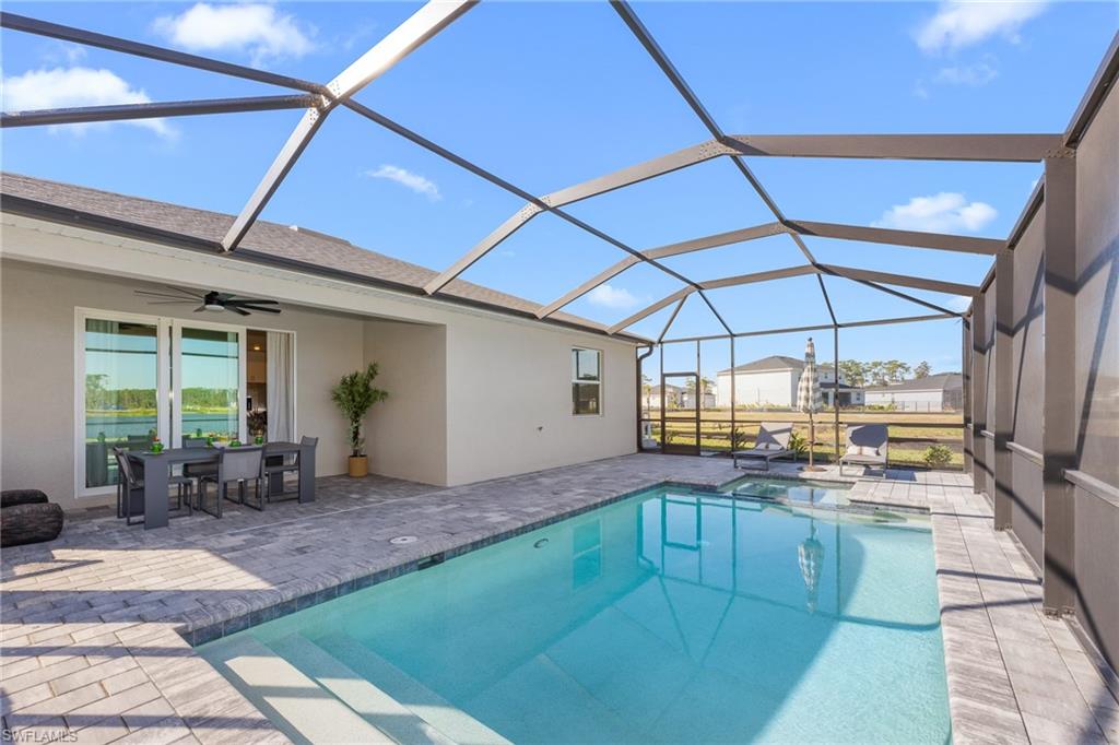 17752 Saddleback Loop North Fort Myers, FL 33917 - Photo 4 of 37 View of swimming pool with a patio, ceiling fan, a pool with connected hot tub, and a lanai