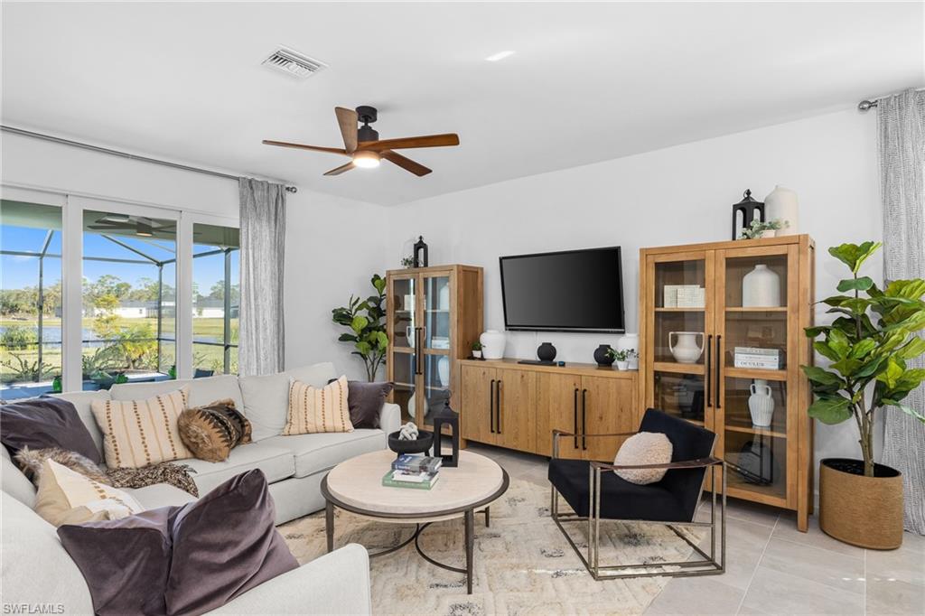 17752 Saddleback Loop North Fort Myers, FL 33917 - Photo 9 of 37 Living room with ceiling fan and light tile patterned flooring