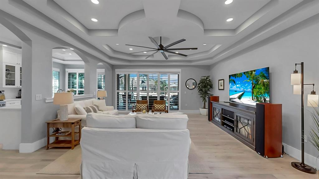 701 Pinckney Drive Apollo Beach, FL 33572 - Photo 15 of 99 a living room with furniture a flat screen tv and a chandelier