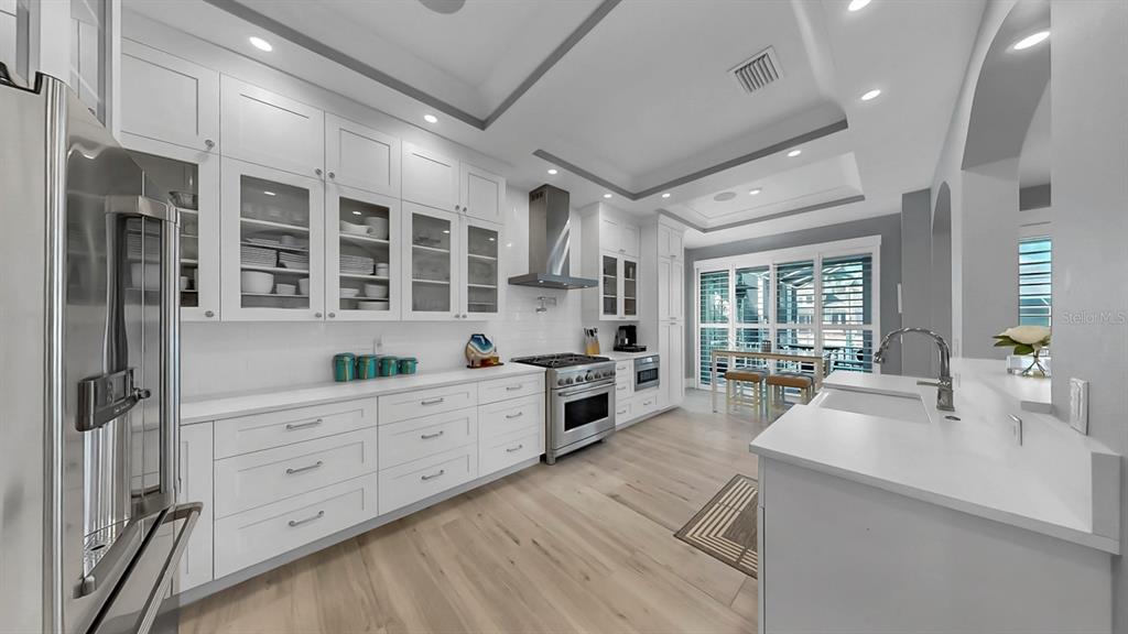 701 Pinckney Drive Apollo Beach, FL 33572 - Photo 18 of 99 a large white kitchen with granite countertop a large counter top appliances and cabinets