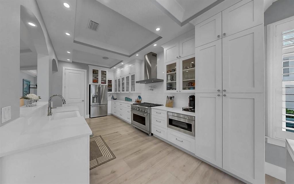 701 Pinckney Drive Apollo Beach, FL 33572 - Photo 20 of 99 a kitchen with stainless steel appliances kitchen island granite countertop a refrigerator oven a sink and dishwasher