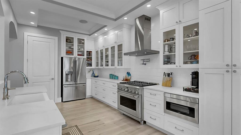 701 Pinckney Drive Apollo Beach, FL 33572 - Photo 21 of 99 a kitchen with stainless steel appliances granite countertop a refrigerator and a stove top oven