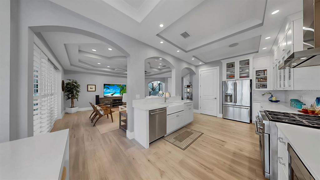 701 Pinckney Drive Apollo Beach, FL 33572 - Photo 23 of 99 a living room with stainless steel appliances kitchen island granite countertop furniture a rug kitchen view and a chandelier