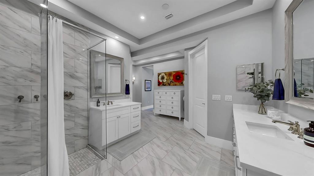 701 Pinckney Drive Apollo Beach, FL 33572 - Photo 32 of 99 a bathroom with a double vanity sink mirror and shower