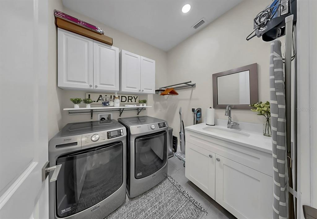 701 Pinckney Drive Apollo Beach, FL 33572 - Photo 35 of 99 a kitchen with a stove sink and cabinets