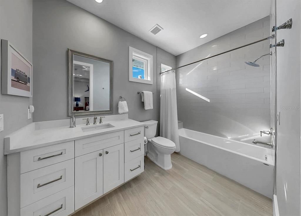 701 Pinckney Drive Apollo Beach, FL 33572 - Photo 42 of 99 a bathroom with a double vanity sink toilet mirror and bathtub