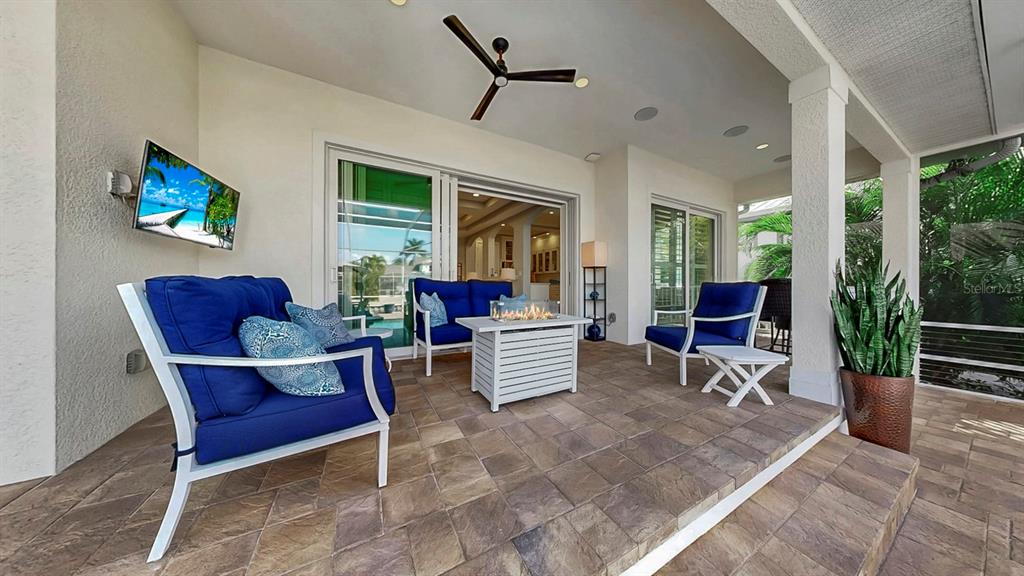 701 Pinckney Drive Apollo Beach, FL 33572 - Photo 52 of 99 a living room with furniture a flat screen tv and a fireplace