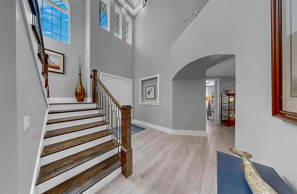 701 Pinckney Drive Apollo Beach, FL 33572 - Photo 9 of 99 a view of a hallway with wooden floor and stairs